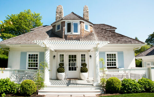 go for a beach-style design featuring a front door pergola, white deck, and light blue shutters