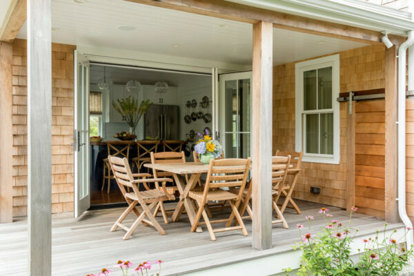 go for a beach style in your small backyard deck with a teak dining set and wood elements