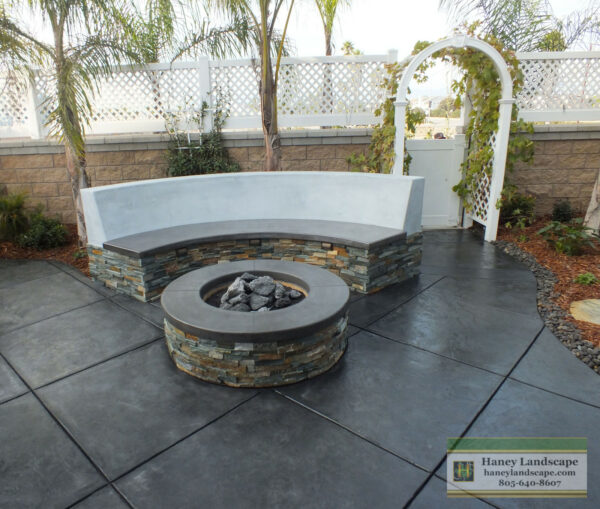 go for a contemporary patio with stamped concrete and a fire pit to enhance the white seat wall