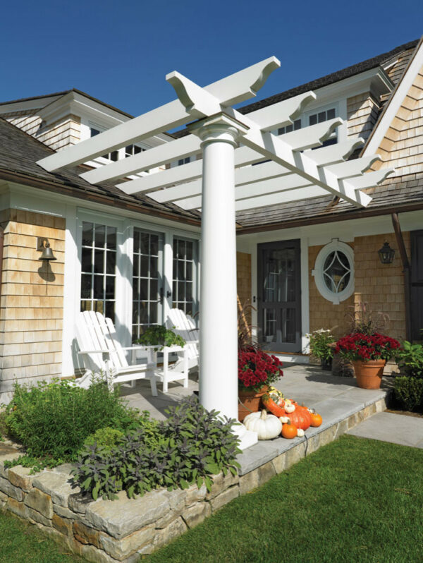 place adirondack chairs under a front door pergola with brown siding to create a victorian inspired mood