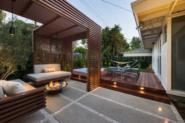this lavish and contemporary small backyard deck features mangarus wood and a steel tubing pergola