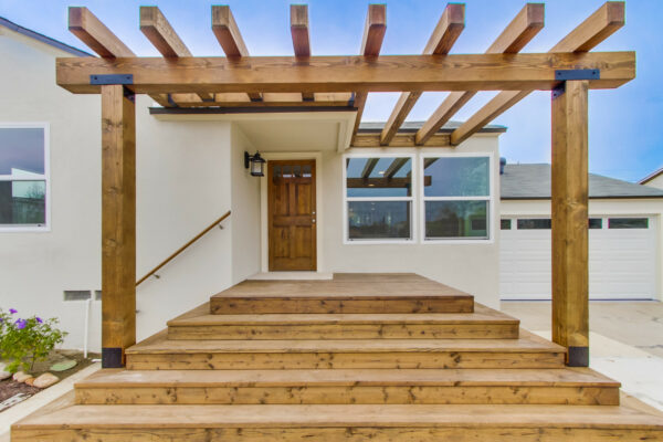 this wooden front door pergola with matching steps create a simple contemporary porch