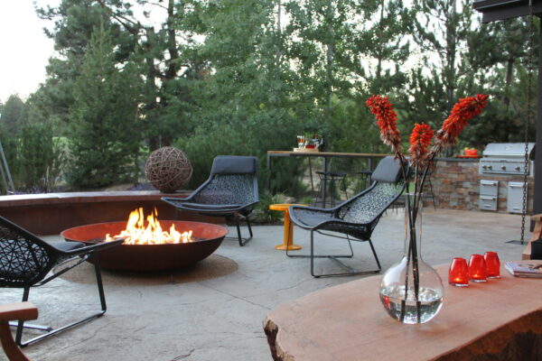use red accents in a stamped concrete patio with a fire pit for a modern minimalist vibe