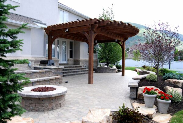 use timber frame for a brown circular front door pergola to evoke drama in a bright patio