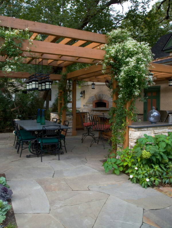 use various colors of irregular natural cleft bluestone and a pergola for a craftsman-inspired patio