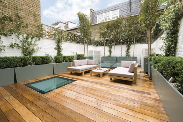 build a cozy rooftop deck with white backyard walls, green planters, and chic outdoor furnishing
