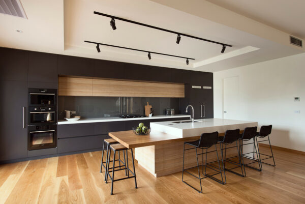 create a contemporary galley kitchen with a large, unique island and modern track lighting