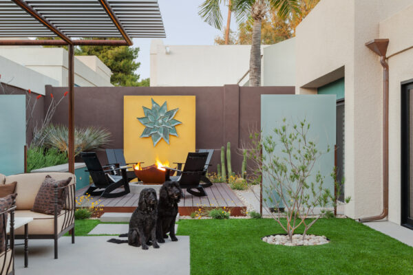 hang artwork on your backyard wall along with a fire pit and resin panels for the ultimate contemporary patio