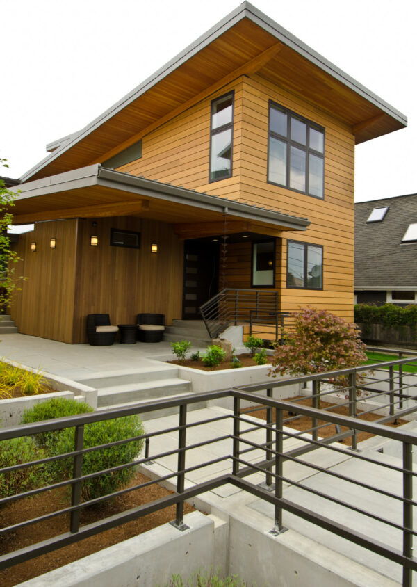 jazz up a 1x4 vertical t&g cedar siding with concrete patio and retaining walls