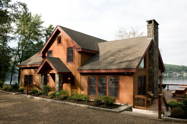this beautiful mountain-style home uses vertical cedar siding and weathered wood roof shingles