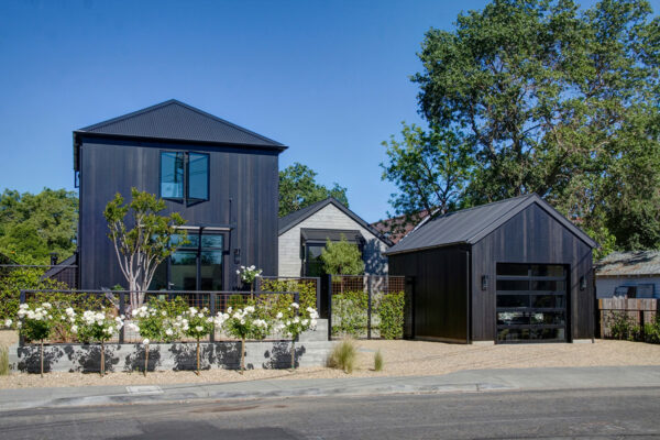 this cottage-inspired black vertical clear-cut cedar siding evokes a rural farmhouse vibe