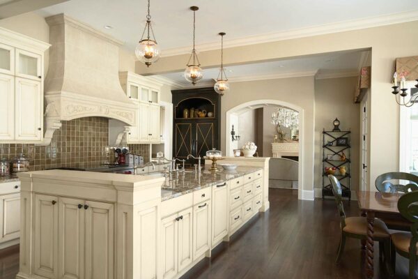 this grand galley kitchen features a spacious island and dining table for a cozy yet luxurious ambiance