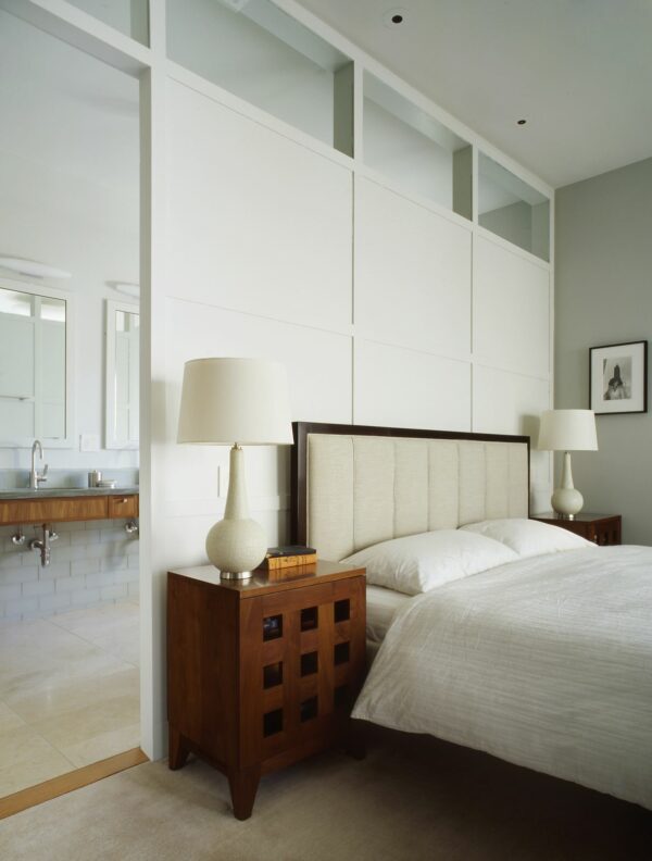 try a white false wall in a grey master bedroom to separate the bathroom in a stylish way