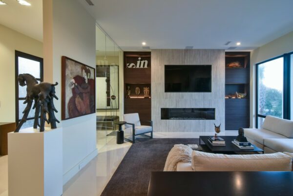 use a false wall and glass to separate two room functions, like this modern living room and exercise studio