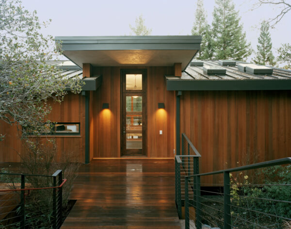 use clear stain on vertical cedar siding with walnut entry door for a luxury wood exterior