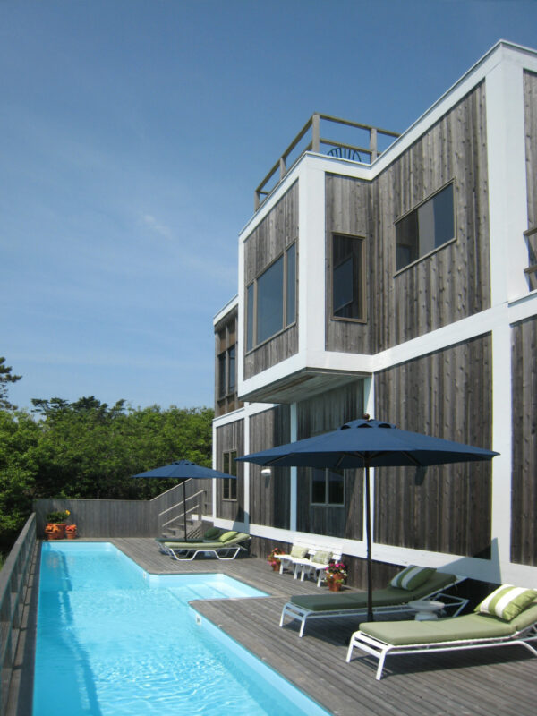 vertical cedar siding and white trim can complement a modern backyard with a pool